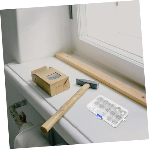 Stainless Steel External Circlip Assortment Kit E Type Retaining Rings displayed on a windowsill with tools for machinery repair.