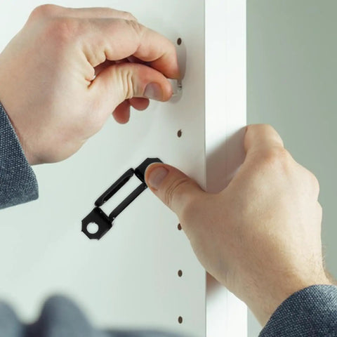 Person installing a 100 Piece Concealed Furniture Fasteners For Floating Shelves And Bookcases Featuring Cold Rolled Steel And Tough Plastic Clips.