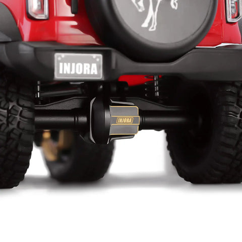 Rear view of vehicle showcasing Brass Front And Rear Axle Diff Covers With Black Hard Coating For TRX4M 1 18 Crawler Upgrade Parts