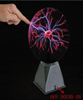 Lit Glass Plasma Ball Light Toy With Touch And Sound Activation 4 Inch Electrostatic Lightning Sphere glowing to a fingertip touch