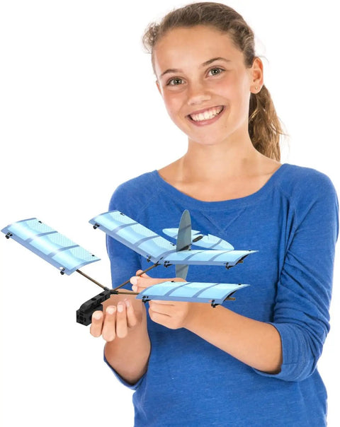 Smiling girl holding a blue glider from the Ultralight Airplane STEM Kit for Kids Build Five Gliders Learn How Planes Fly Aerodynamics and Physics Design Your Own Glider Ages 8 Plus Hands On Flight Experiments