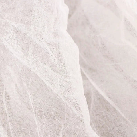 Close-up of White nonwoven material for 10 Pcs Disposable Nonwoven Bouffant Hair Caps With Straight Comfort Elastic Fit For Full Head And Face Shield.