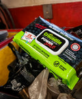 PowerSCRUB Dual-Surface Cleaning Wipes Heavy-Duty Moist Cloths 80 Count pack on a workshop table.