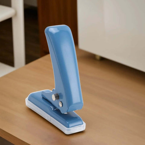Blue Compact Five Point Five Millimeter Hole Puncher Built Tough Metal Handheld Punch on wooden desk.