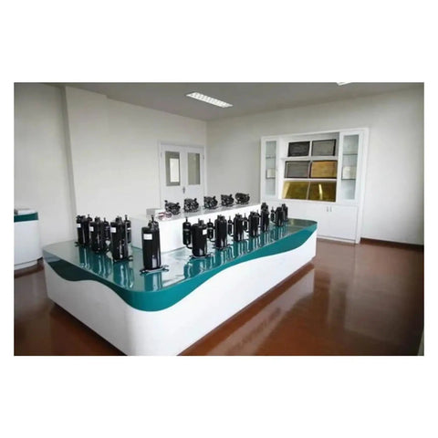 Heavy Duty R290 Hermetic Rotary AC Compressor for Your RV Caravan Rig displayed on a table with a modern background.