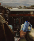 Solid Double Wall Vacuum Insulated Flip Straw Travel Tumbler With Secure Leakproof Lid Keeps Drinks Ice Cold All Day Long Rose Quartz Thirty Ounce Portable Cup For Gym Hiking And Daily Grind in a car cup holder.