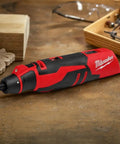 Badass Brushless Cordless Rotary Tool Kit With Whopping Variable Speed Range 5000 To 27500 Rpm And Redlink Intelligence on wooden surface.