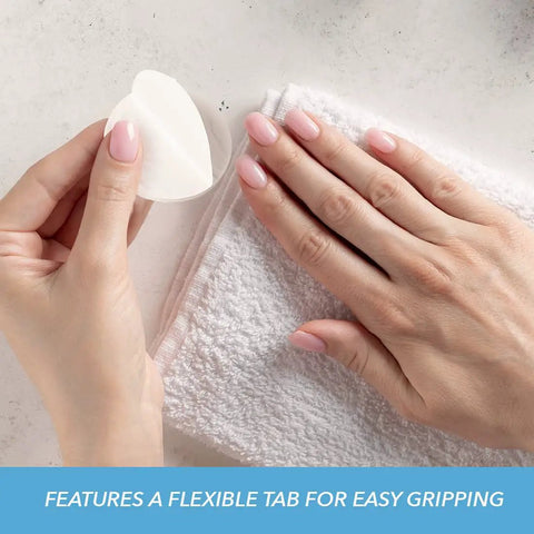 Lint Free Premium Nail Wipes 1.75 Inch Cotton Rounds For Removing Nail Polish With Easy Grip Tabs in hand next to nails