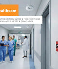 Rugged Wireless LoRaWAN Smoke And Heat Detector With No Fuss Setup And Marathon Battery Life Featuring Slick Cloud Monitoring For Heavy Duty Commercial Sites installed in a healthcare corridor.