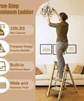 Foldable 3 Step Stool Ladder In Gold Aluminum For Kitchen And Closet Ultra Lightweight With 330 Lb Capacity Anti Slip Wide Pedals Portable For Kids And Adults No Assembly Required Space Saving Design Folded Thickness 1.9 Inches, woman standing on 3-step ladder in living room