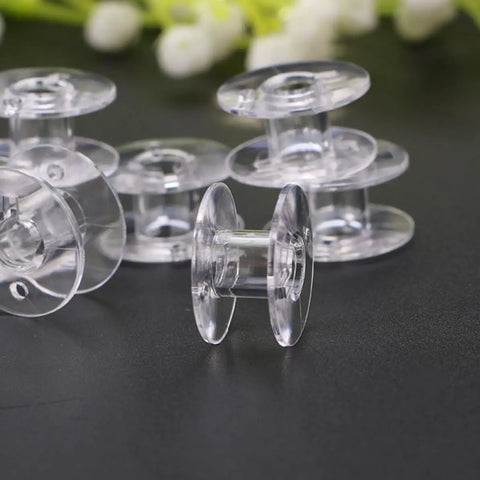 Clear plastic bobbins for 15 Piece Sewing Machine Tool Kit With Bobbins, Screwdrivers, Seam Ripper, Threading Tool And Brush For Home Use And Beginners Easy DIY Sewing Supplies For Quick Repairs And Small Projects.