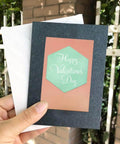 Greeting card with hexagon die cut from Six Piece Cutting Dies Set For Card Making And Scrapbooking, held in hand outdoors