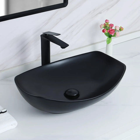 Black ceramic vessel sink with matte finish on white marble counter and vase, resembling White Ceramic Vessel Sink 19 By 14.5 Inch With Pop Up Drain Above Counter Bathroom Sink Modern Vessel Bowl For Vanity Durable Glazed Ceramic Finish Countertop Sink For Stylish Homes