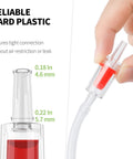 Close-up of Pawfly aquarium check valve in clear plastic with red insert, connected to 3/16 in airline tubing