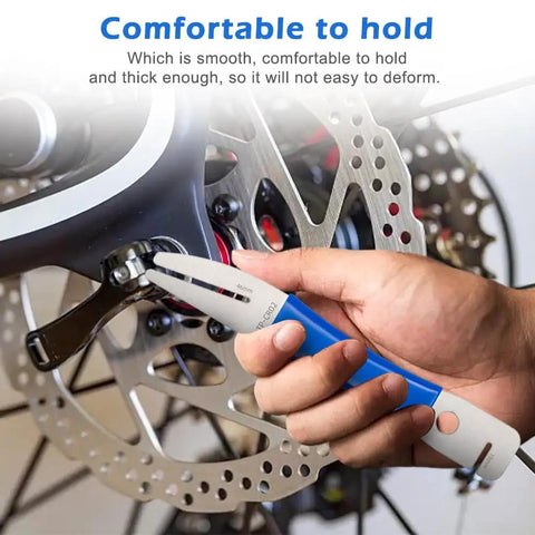 Hand using Rotor Truing Fork Tool For Bike Disc Alignment And Rotor Straightening No Fuss Blue Bicycle Disc Rotor Alignment Tool.