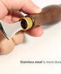 Close-up of hand holding Leather Edge Creaser Set With Stainless Steel Tips 1.0mm to 2.5mm and wood handle for leatherworking.