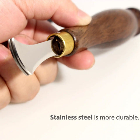 Close-up of hand holding Leather Edge Creaser Set With Stainless Steel Tips 1.0mm to 2.5mm and wood handle for leatherworking.