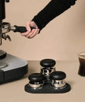 Top Shelf 58mm Espresso Coffee Tamper Set With Spring Loaded Distributors and Powder Tools Plus Magnetic Leveler Pro Barista Gear, featuring a hand-held tamper.