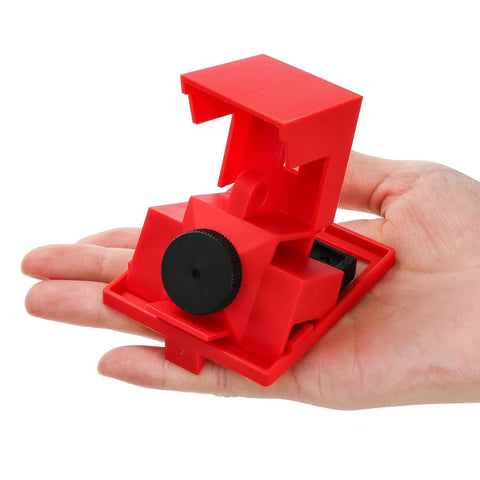 Red clamp-on circuit breaker lockout device for 480-600V single and multi-pole breakers, shown in hand, large size, OSHA compliant.