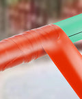 Heavy Duty Waterproof Tape To Fix Leaks Fast Duct And Plumbing Repair Tape Outdoor Adhesive Sealant Silicone Rubber Red Leak Stopper Weatherproof Patch Tape 2X2 Inch wrapped around a green pipe corner for leak sealing.