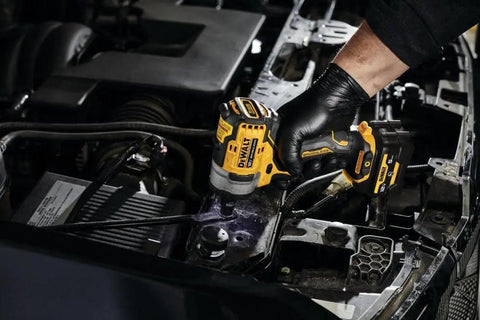 12V Max 3/8 Inch Cordless Impact Wrench Kit delivering hella tight torque in a mechanic's hand while working on a car engine.