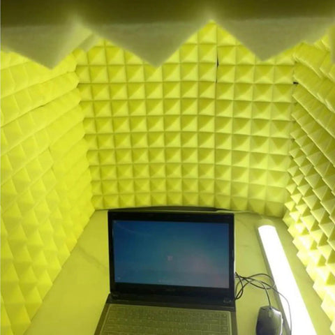 Solid Portable Desktop Soundproof Booth Cube Packed With Dense Acoustic Foam Panels, yellow interior with a laptop for recording.