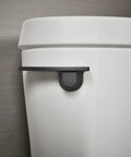Betello Left Hand Trip Lever Matte Black for Betello Toilets seen on white toilet tank