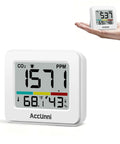 Handy Portable CO2 Monitor And Indoor Air Quality Tracker With Dead On Temperature Humidity Readings Foldable Stand White compact size in hand.