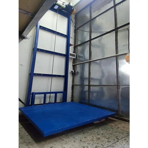 Rock Solid Steel Electric Cargo Lift Platform With Smooth Monorail Hoist For Warehouse And Home Use Effortlessly Moves Up To 200 Kgs No Sweat Operation Built Tough For Dependable Daily Heavy Loads in blue with steel frame and hoist.