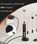 Rechargeable Milk Frother Handheld With 3 Detachable Stainless Whisks 3 Speed Adjustable Drink Mixer Mini Frother Wand visible with charging base and whisk storage