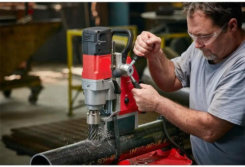 Heavy Duty Magnetic Drill Kit With Badass 13 Amp Motor And Hella Strong Hold On Quarter Inch Steel For Smooth Cutting, operating on steel pipe.
