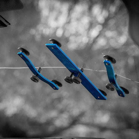 Crack Jack Windshield Repair Tool for Long Cracks Durable Auto Glass Quick Fix with blue devices on a cracked windshield.