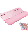 Ergonomic Keyboard Wrist Rest Stand for Desktop With Tilted Riser And Comfy Wrist Pad For Comfortable Typing At Office Home Or School Pink For All Day Comfort, shown in pink acrylic with a foam wrist pad, angled view with hands typing.