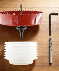 Moretopgood 6 Inch HSS Bi-Metal Hole Saw Kit With Arbor And Dust Bowl on wooden surface with hex key and drill bit.