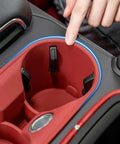Close-up of Porsche Macan Center Console Organizer Tray 2 Piece Set Silicone Cup Holder Storage Protective Pad 2022-2026 installed