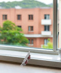 Four Pack Heavy Duty Stainless Steel Double Wheel Sliding Door Roller Assembly With A Slick Polished Finish And Rock Solid Wear Resistant Pulleys For Zero Hassle Window Track Operation on a window sill.