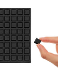 Eighty Piece Half Inch Square Self Adhesive Silicone Rubber Feet With Killer Non Slip Grip For Furniture Electronics And Appliances No Mess Peel Stick Bumper Pads That Hold Firm displayed on a sheet with one being held.