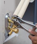 Adjustable wrench securing Insulation Foam Tube For Pipes And Mini Split Lines, Half Inch Inner Diameter, Nine Millimeter Wall on HVAC unit.