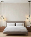Lamparko Small Pendant Light Fixture with Crystal Cube, Brushed Nickel hanging above a modern bed in a stylish bedroom setting.