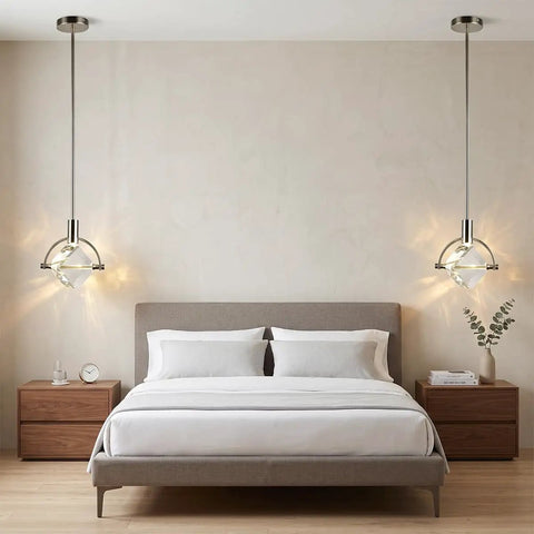 Lamparko Small Pendant Light Fixture with Crystal Cube, Brushed Nickel hanging above a modern bed in a stylish bedroom setting.