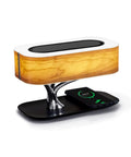 Masdio Bedside Lamp With Bluetooth Speaker And Wireless Charger Sleep Mode Stepless Dimming Table Desk Lamp illuminated on table.