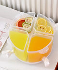 Five Point Five Liter Rotating Beverage Dispenser With Four Separate Compartments And Dripless Spigot filled with colorful juices and fruit slices.