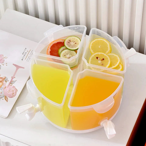 Five Point Five Liter Rotating Beverage Dispenser With Four Separate Compartments And Dripless Spigot filled with colorful juices and fruit slices.
