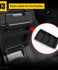 Elastic band fixating center console cover for 2013-2018 Nissan Altima armrest, black faux leather with stitching and non-slip backing.