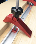 Close-up of Rock Solid Aluminum T Track Hold Down Clamps securing a wooden workpiece on T slot system, ideal for woodworking.