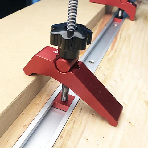Close-up of Rock Solid Aluminum T Track Hold Down Clamps securing a wooden workpiece on T slot system, ideal for woodworking.