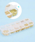 Golden Filigree Flower Bead Caps Set With 240 Pcs 12 Unique Brass Petal Ends in a clear storage box.