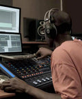 Man using 4 Channel Bluetooth Studio Mixer DJ Controller Interface With USB Recording For PC And Mac XLR Microphone Input And 48V Phantom Power