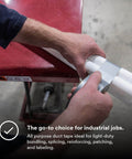 Person using Industrial Strength Silver Duct Tape 1.88 Inch By 60 Yard Pack Of 3 for bundling white pipes on red table