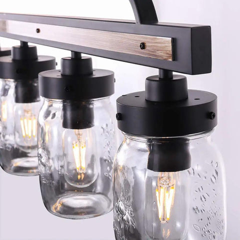 Close-up of Farmhouse Black Mason Jar Chandelier For Kitchen Island And Dining Table with faux wood and glass shade.